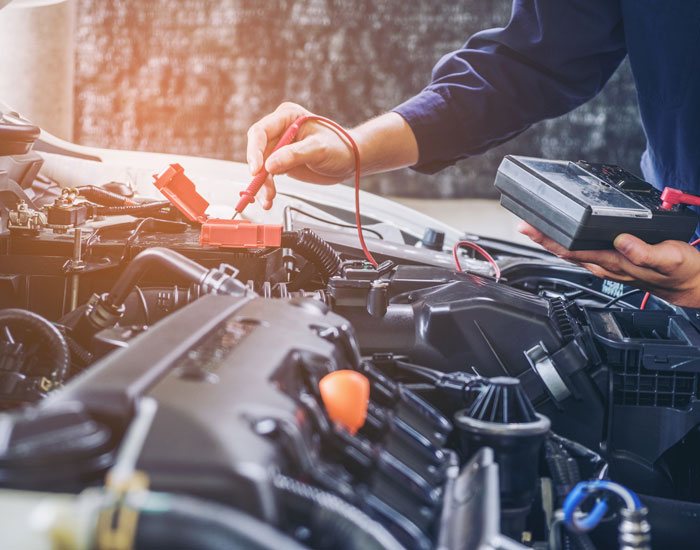 Mechanic checking car battery